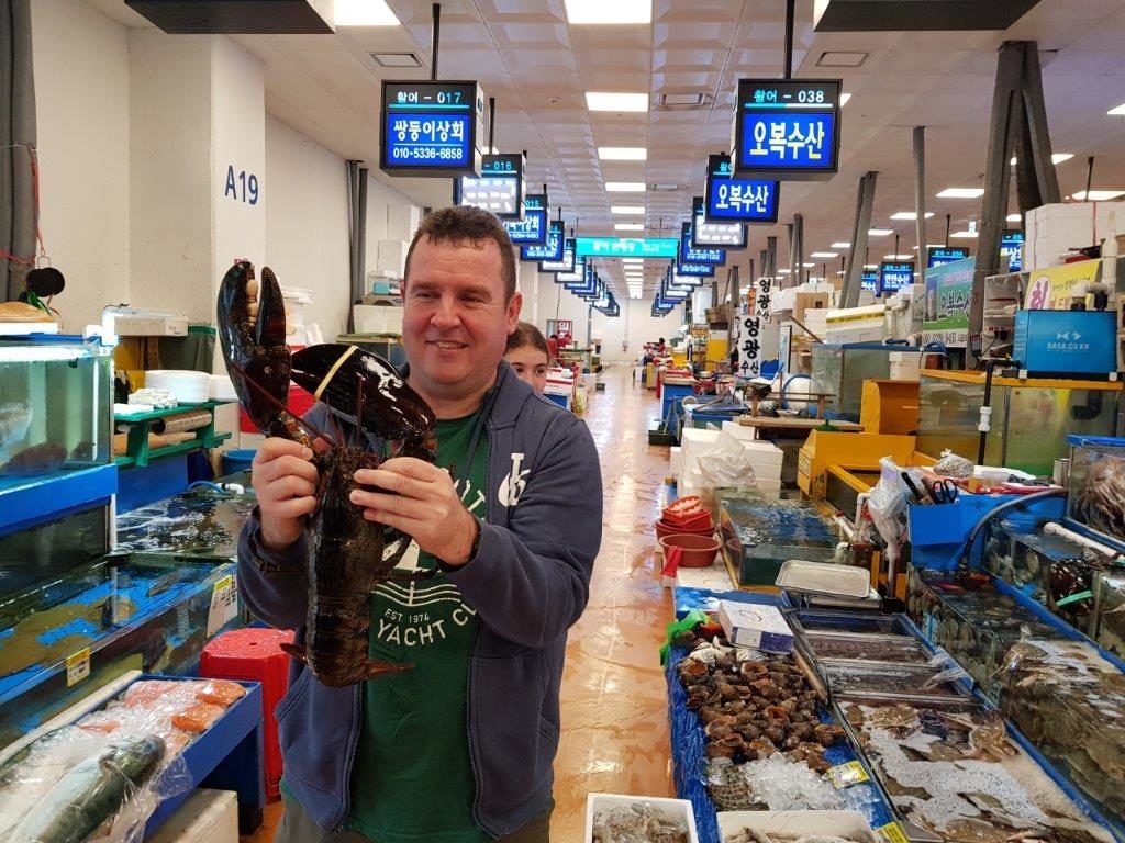 Tony getting up close and personal with a lobster at Noryangjin Fish Market in Seoul, South Korea